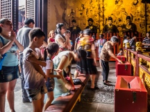 People making offerings at the Taoist temple